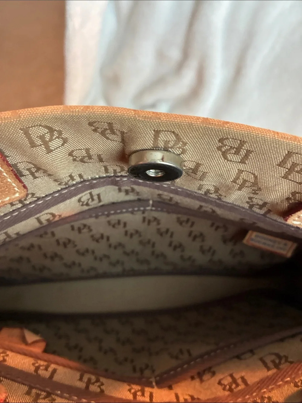 Dooney & Bourke  Brown Monogram Handbag with Tassel Accent
